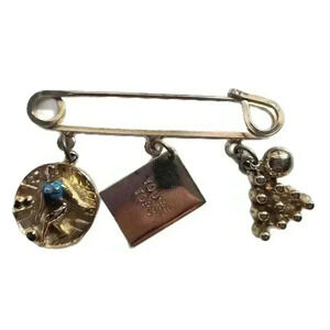 This vintage gold tone bowling pendant charm safety pin